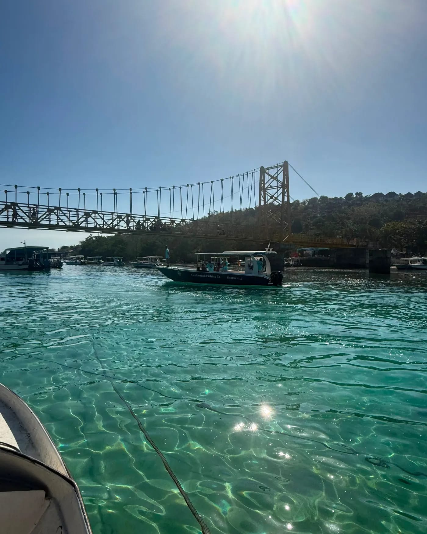 The charter boat moored in clear shallow water