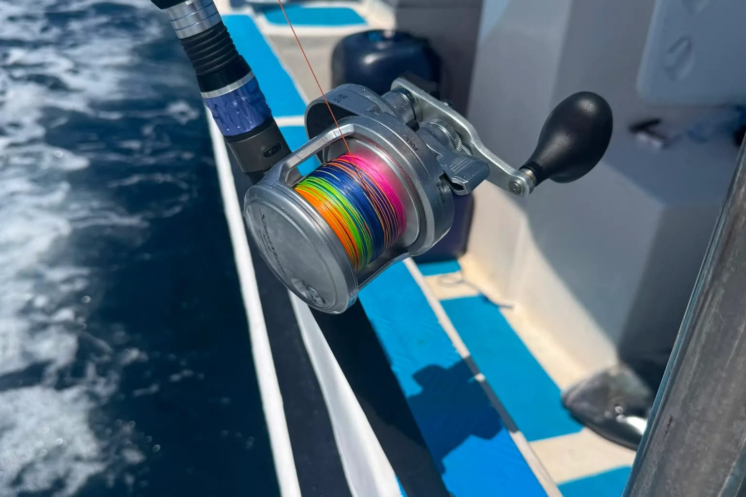 Close-up of a big-game reel spooled with braid, mounted on the rod