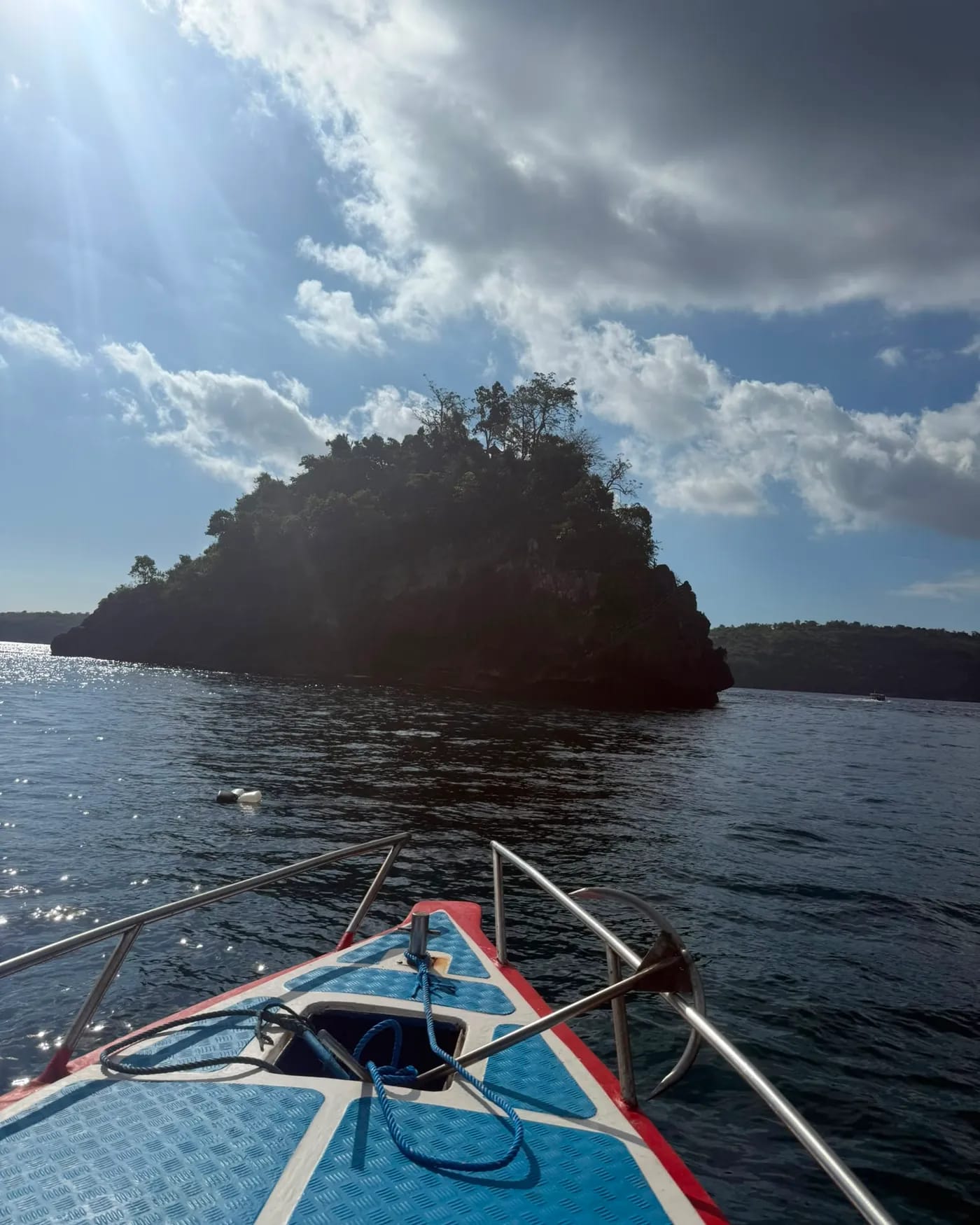 A rocky headland rising from the sea near Nusa Penida